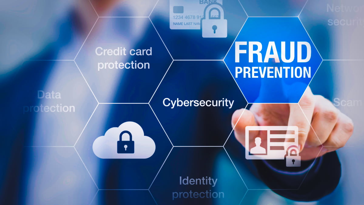 Business professional touching fraud prevention hexagon on digital interface, highlighting cybersecurity against examples of business fraud