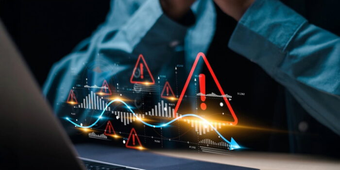 Digital financial dashboard with warning alerts and declining graphs showing monitoring systems used for how to prevent business fraud
