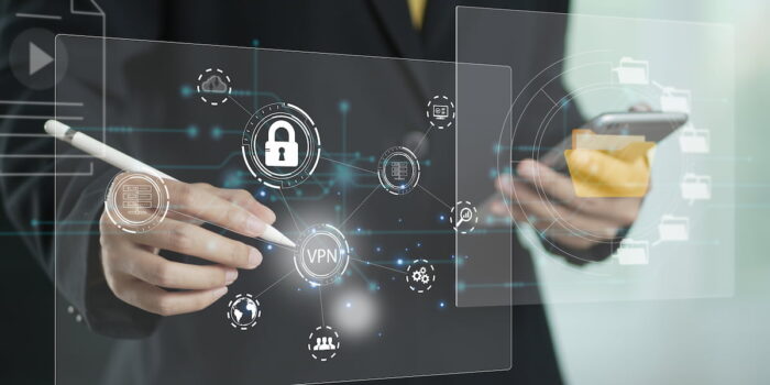 Business professional using digital tools to manage data security and VPN access as part of effective fraud risk management strategy