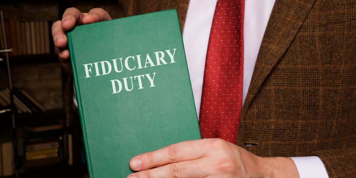 lawyer holding a fiduciary duty book