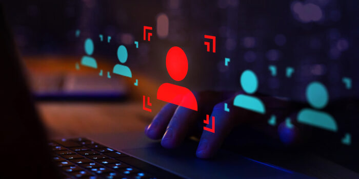 Red silhouette of person surrounded by digital security elements representing employee fraud detection and prevention systems
