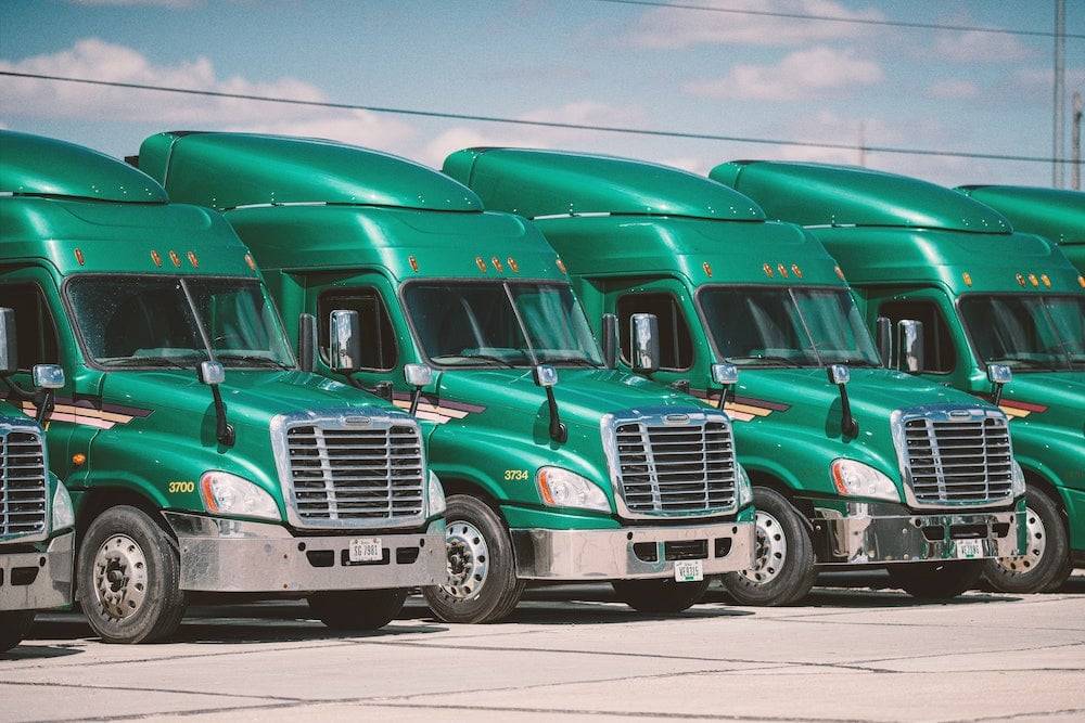 Truck Accidents: Green Semi-Trucks in a line