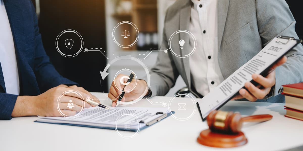 Business professionals reviewing legal documents and discussing what does an intellectual property lawyer do beside a gavel in an office setting